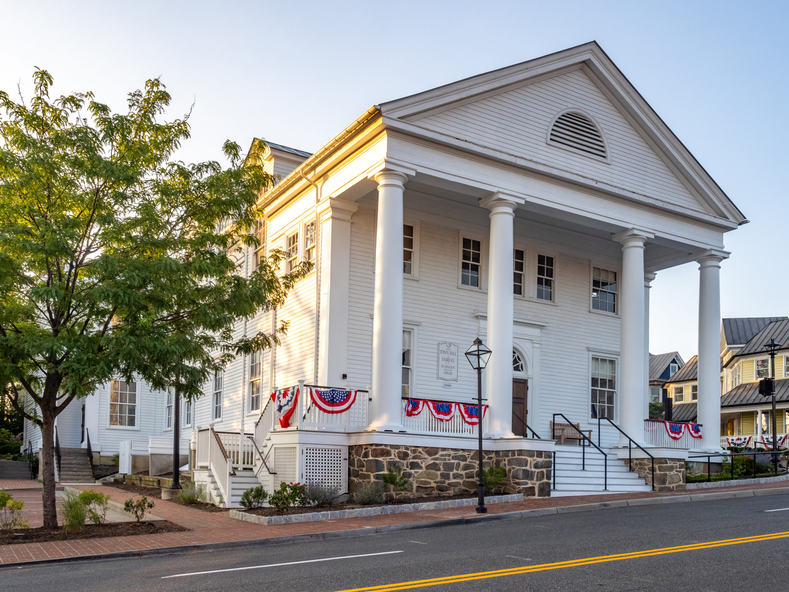 White columns and patriotic bunting at Old Town Hall in Fairfax, Virginia