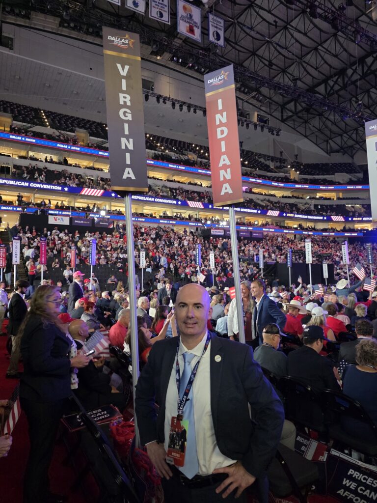 Matt Braynard beneath the Virginia delegation placard at the RNC Midterm Convention in Dallas.