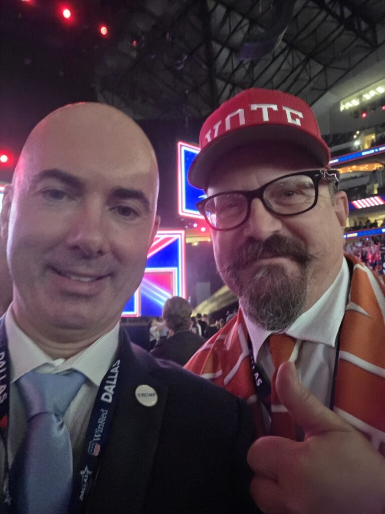 Matt Braynard takes a selfie with the “Brick Wall” guy at the convention.